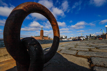 Fototapeta premium Stockholm, Sweden The City Hall or Stadshuset seen through a ring on the quayside.