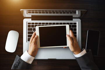 Top view business hand working with laptop computer, tablet and smart phone in office