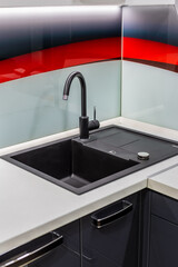 Fototapeta na wymiar Nice new sink in the kitchen. Kitchen Design.