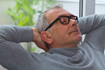 Obraz premium satisfied and relaxed man on the sofa at home