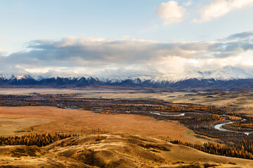 Top view of the Kurai steppe, the Chuya river and the North Chuya ridge in autumn at sunset. Altai Republic, Russia