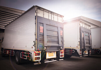 Trucks Parking at The Warehouse. Truck with Lift Ramp. Cargo Freight Transportation. 