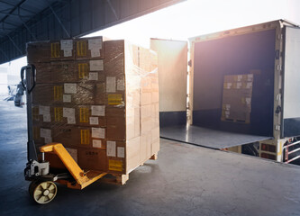 Package Boxes Loading into Container Truck. Truck Parked Loading at Dock Warehouse. Delivery...