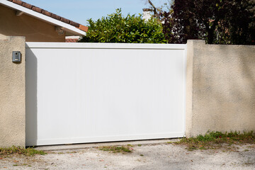 portal sliding white steel garden gate in front of suburb family home