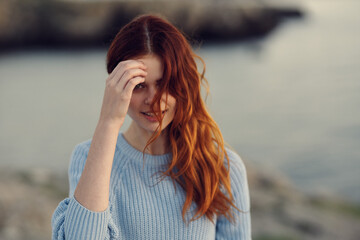 happy traveler in the mountains blue sweater model hairstyle nature