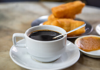 A cup of coffee and a snack,select focus.