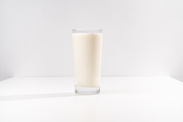 a glass of milk on a white background. selling farm products. Place for the inscription.