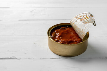 Fish tin can on white wooden background