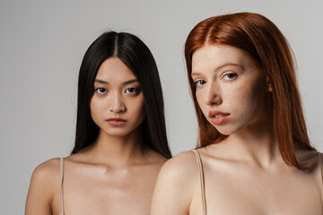 Close up studio portrait of two beautiful young girls