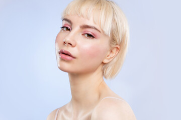 Cool sensual young blond girl with natural make up and healthy glowing ideal facial skin. Female...