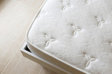 Close up shot of white orthopedic mattress surface pattern with a lot of copy space for text. Hypoallergenic foam matress for proper spinal alingment and pressure point relief. Background, top view.