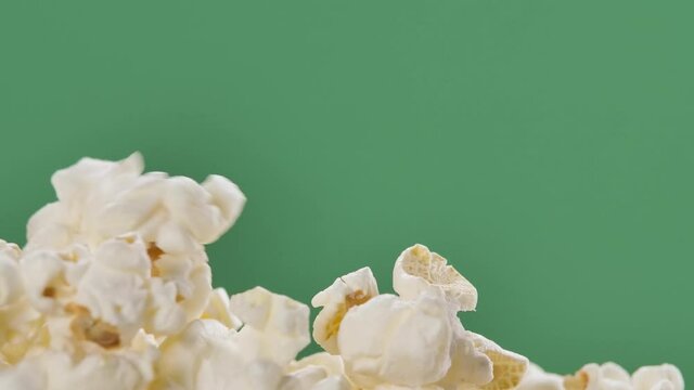 Fresh popcorn falls on top of a pile Isolated on ChromaKey Background