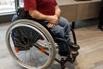 Obraz premium A young man in a wheelchair who can't get up the stairs in Belarus