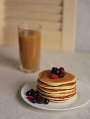 Sweet Homemade Stack of Pancakes with Butter, berries and Syrup for Breakfast 