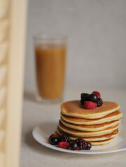 Sweet Homemade Stack of Pancakes with Butter, berries and Syrup for Breakfast 