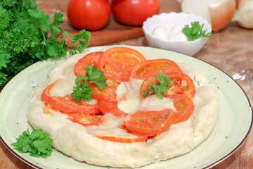 homemade pie with fresh tomatoes and mozzarella