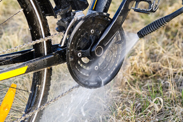 Bicycle washing on backyard. spring preparations for the cycling season. DIY bike care, pressure bike wash