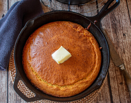fresh baked cast iron corn bread with butter topping