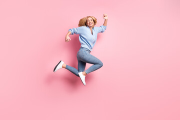 Fototapeta na wymiar Full size profile side photo of young happy excited careless girl running in air isolated on pink color background