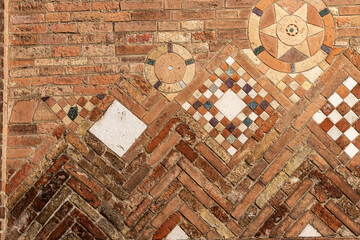 Closeup of the ancient brick wall of the Basilica of Santo Stefano also called the Seven Churches in early Christian, Romanesque and Gothic style. Bologna, Emilia-Romagna, Italy, Europe.