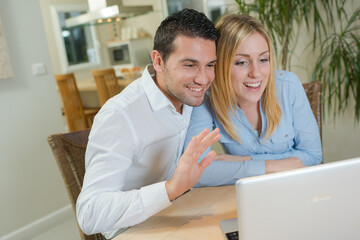 a couple is on laptop