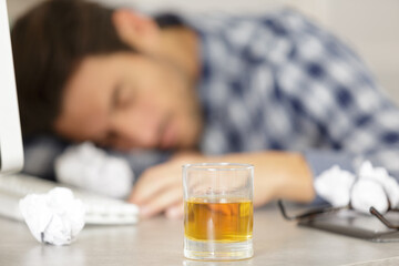 young handsome employee sleeping at workplace