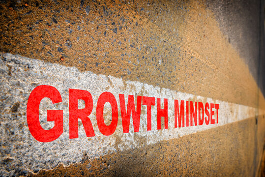 Growth mindset word on asphalt road with sand and white marking line. Self development to success concept and challenge idea