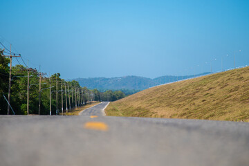 Beautiful view in ant eye view along the road with blue sky and the forest scene for travel concept idea