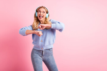 Photo of young happy excited smiling positive woman dancing listen music in headphones isolated on pink color background