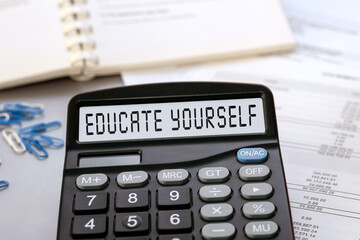 Calculator with the words EDUCATE YOURSELF on the display