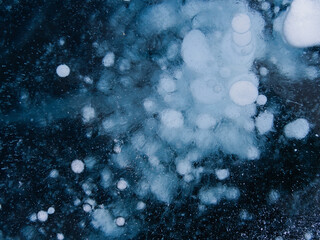 gas bubbles frozen in the ice of Lake Baikal form a picture similar to the starry sky. Siberia Russia