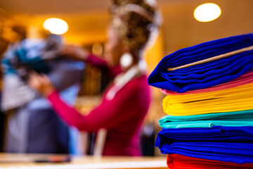 dark skinned business woman salewoman working at textile shop