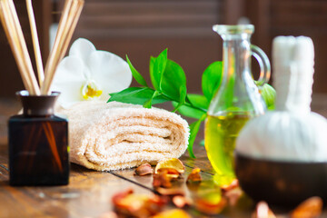 Spa background. Towel, candles, flowers, aroma sticks, massaging stones and herbal balls. Massage, oriental therapy, wellbeing and meditation.