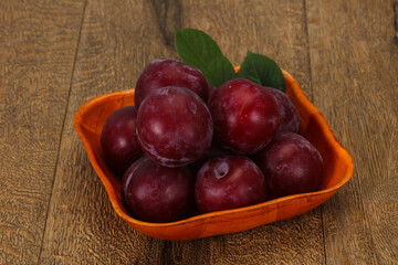 Plum heap in the wooden basket