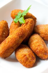 various homemade croquettes on a white plate. Spanish typical food