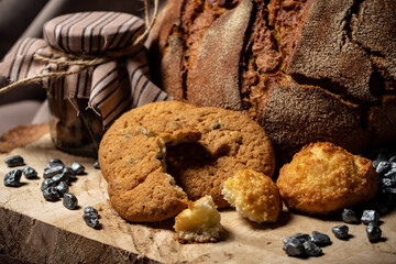 Liver and bread next to a jar on a wooden stump on a brown background