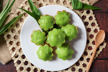 Pandan Pancake - Thai dessert made from pandan, flour, coconut milk and sugar : In Thai called Kanom Krok Bai Toey or Kanom Krok Singapare at top view on wooden background