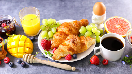 continent breakfast with coffe cup, croissant and fresh fruits