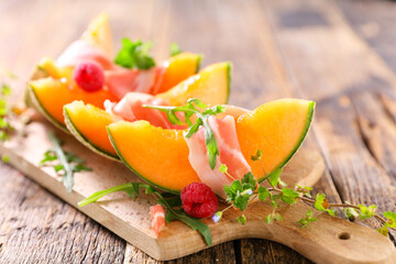 melon slice with prosciutto ham and basil