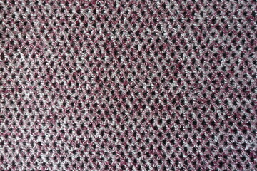 Pink, grey and white woolen fabric with diamonds pattern from above