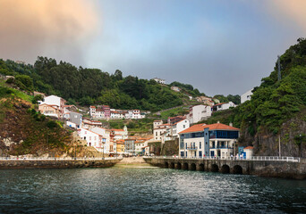 Fototapeta na wymiar Sunset view from the sea of ​​the Asturian town of Cudillero, on the Cantabrian coast.