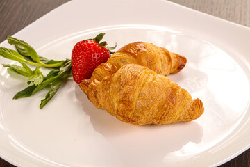 Sweet croissant in the plate
