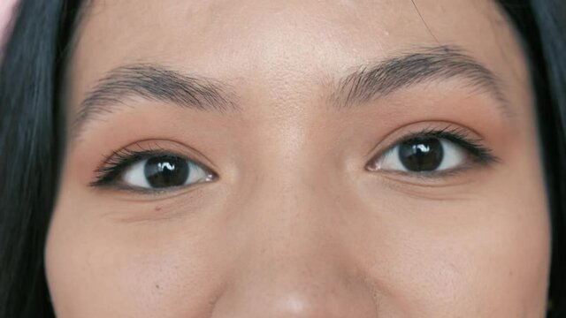 close up beautiful hazel eyes opening woman wearing makeup eyeshadow cosmetics macro beauty concept. Macro of hispanic latin woman eyes looking at camera