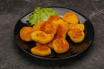 Fried chicken nuggets served salad leaves