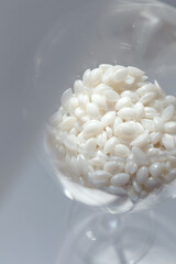 Hard wax for depilation and wooden sticks on white background. Discount banner, flyer, love your body, copy space.