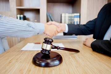 Lawyer consultant shaking hand with client in law firm
