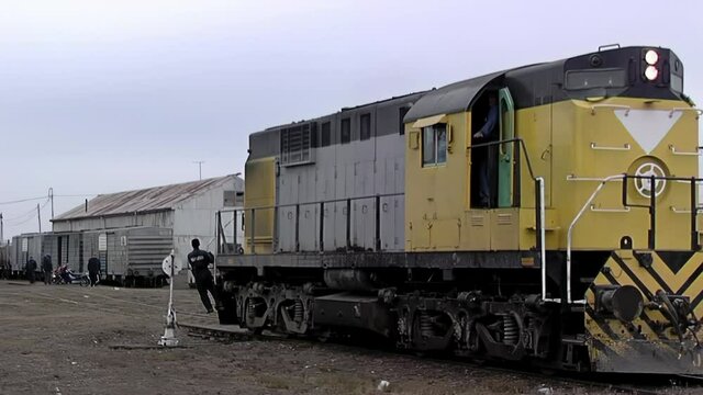 Railway Worker Hanging on Front of Moving ALCo Locomotive While Signaling Engineer, Tren Patagonico, Viedma, Rio Negro, Argentina
