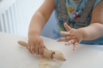 cute little girl playing game with dough and flour