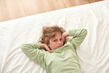Boy feels not good while lying in bed