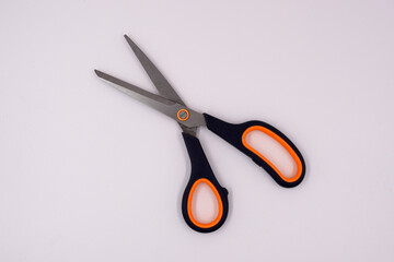 Angled view of a black and orange scissors